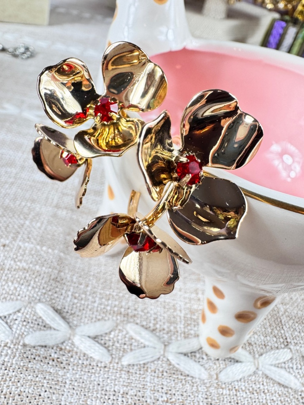 Zara Gold Floral Hoop Earrings with Red Crystal Centers